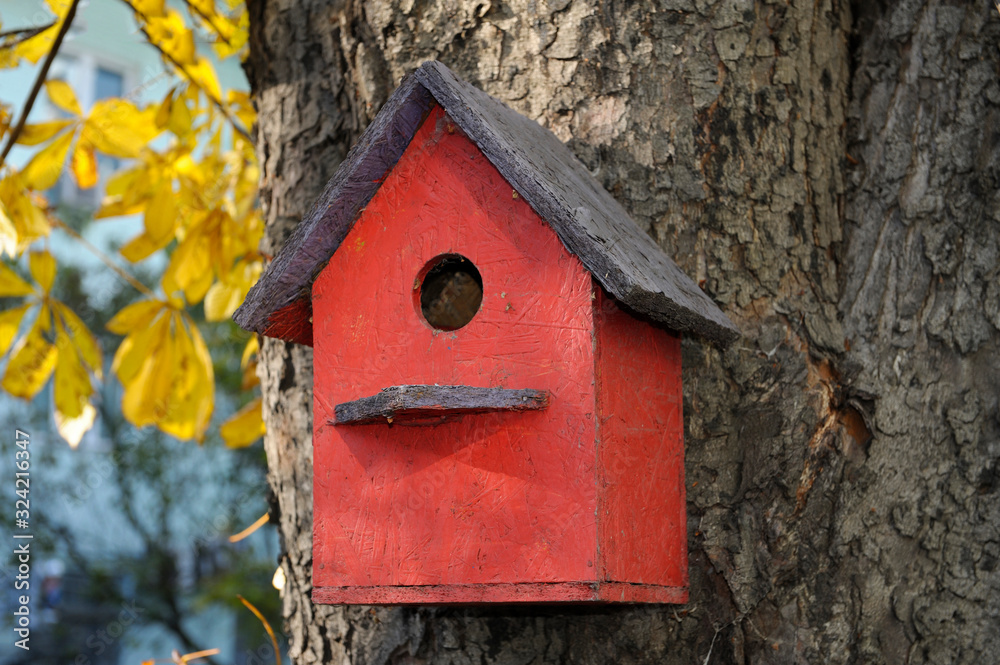 Handmade wooden nesting boxes hanging on a tree