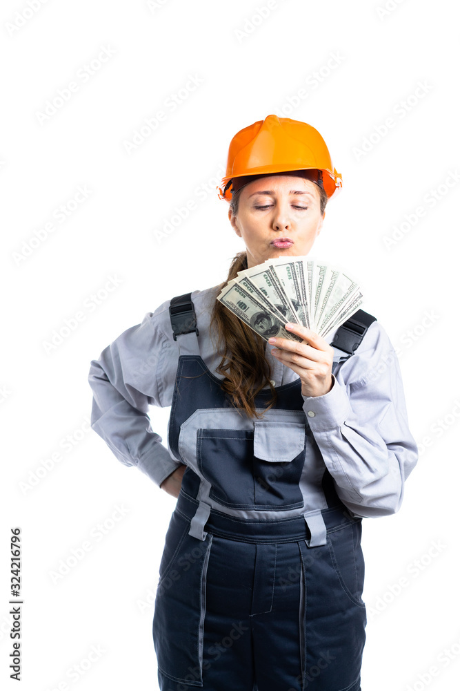 Builder engineer girl with money in her hand rejoices in so many dollars. Isolated Builder engineer girl with money in her hand rejoices in so many dollars. Isolated