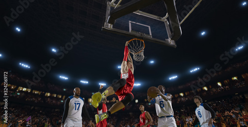 Basketball players on big professional arena during the game. Tense moment of the game. View from below the basket © haizon