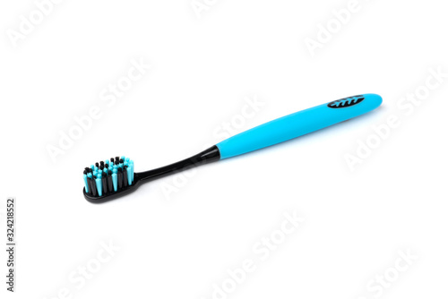 Blue toothbrush with black bristles isolated on white background.