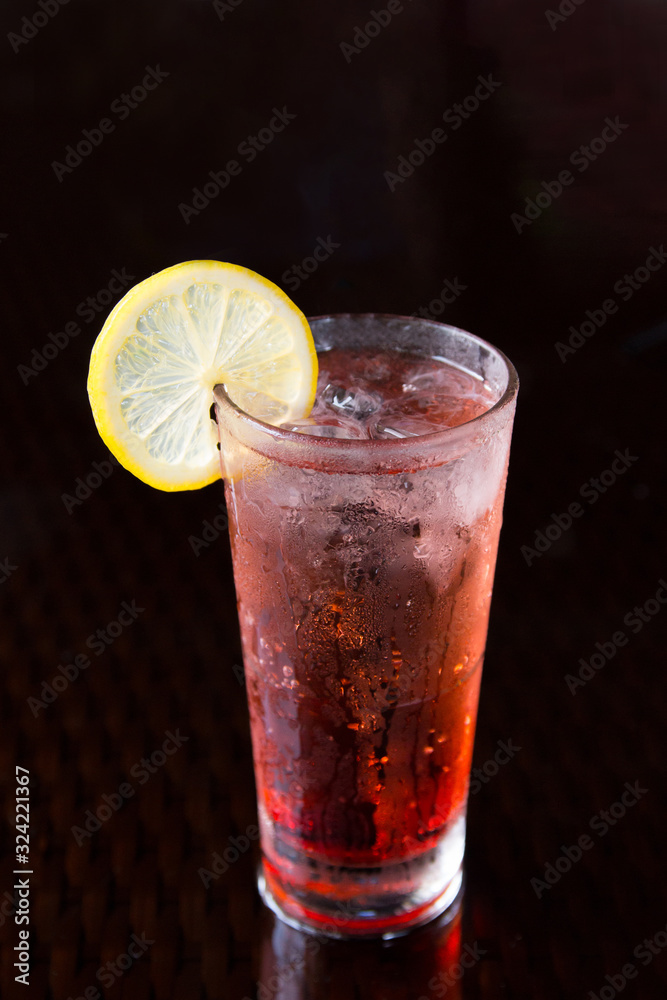 Homemade red cranberry lemonade cocktail on a black background. Homemade red cranberry lemonade cocktail on a black background.
