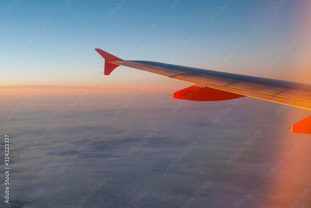 Fototapeta premium A view of the sunset sky through an airplane window. Sunset on the horizon
