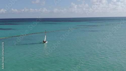 Two catamarans sailing in tropical ocean, Caribbean Sea watersports and fun at beach photo