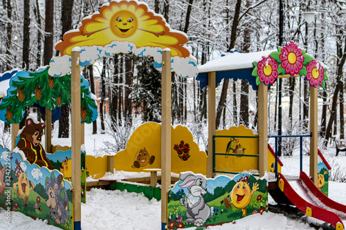 Winter. Playground the sun decorated with drawings of a bear, a bunny, a hedgehog and a kolobok. photo