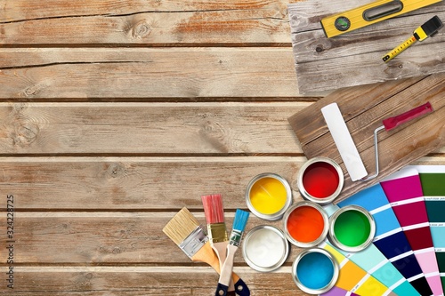 Fototapeta Naklejka Na Ścianę i Meble -  Paint brushes and paint cans for repair on wooden desk
