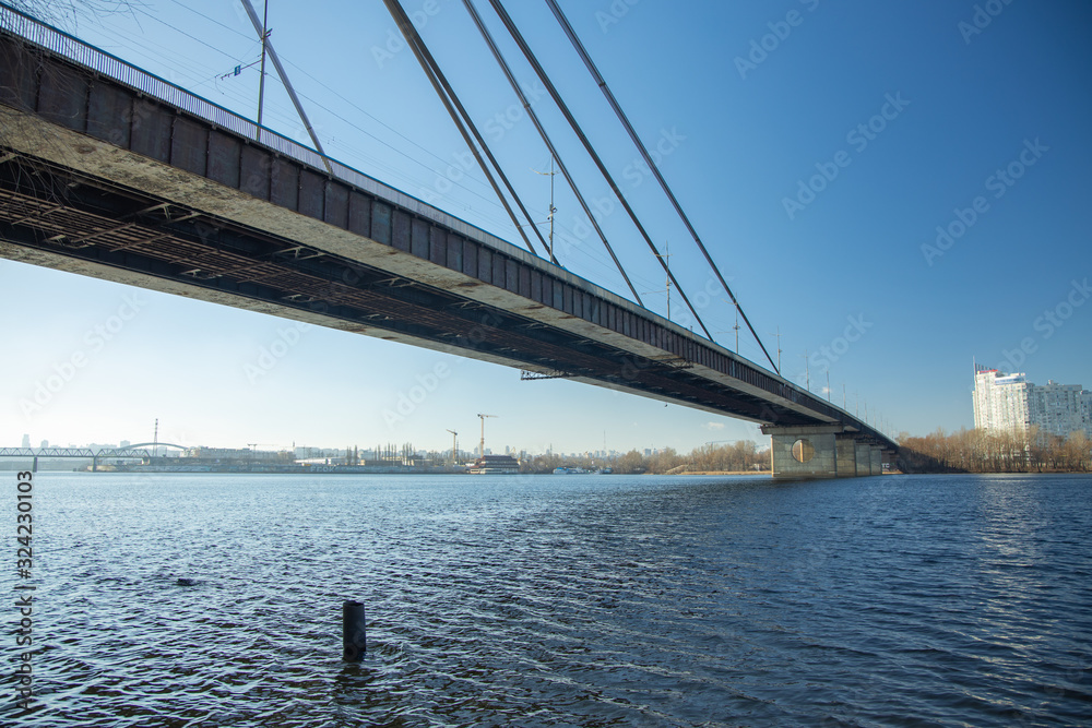 Fototapeta premium North bridge over the Dnieper river in Kiev in early spring on a sunny morning.