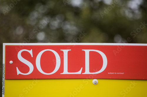Red sold sign Unitd Kingdom UK England. Real estate investment portfolio houseing market British economy concept idea