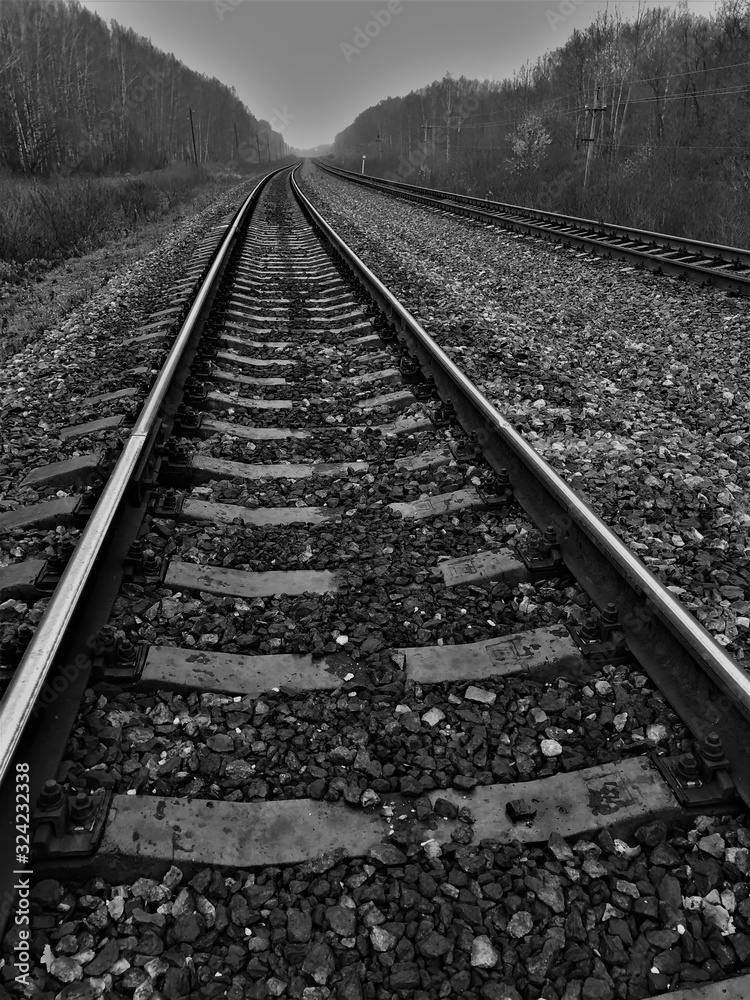 black and white photo railway go far