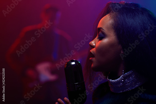 Canvas Print A jazz singer and guitarist perform on stage.