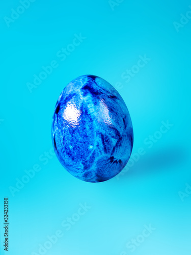blue colored holiday egg on a blue background
