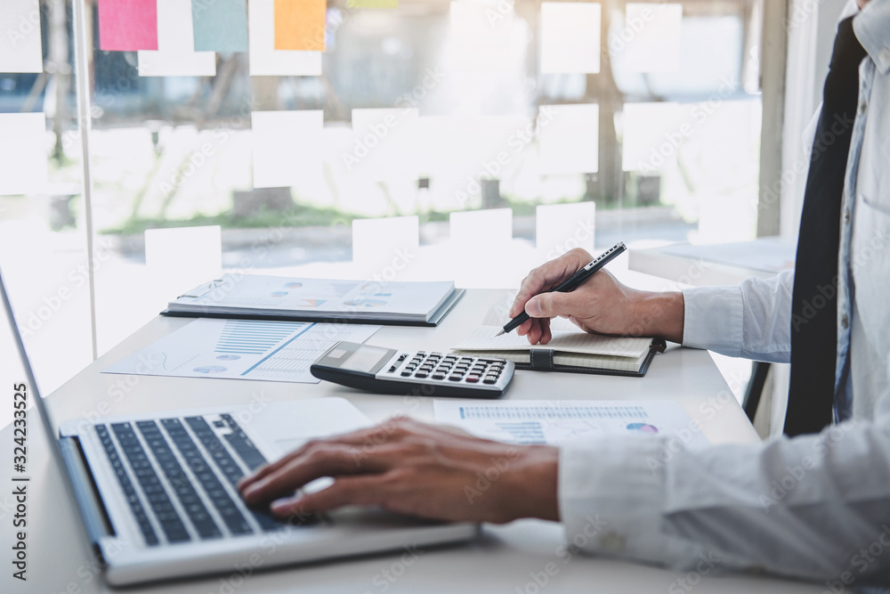 Professional at work, businessman working and analyzing on laptop with calculate statistics of financial document data graph for new project of business strategy and market growth at workplace