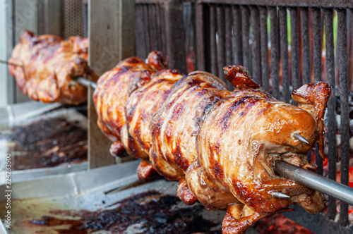 Rolling grilled chicken at a steet food shop in Thaland