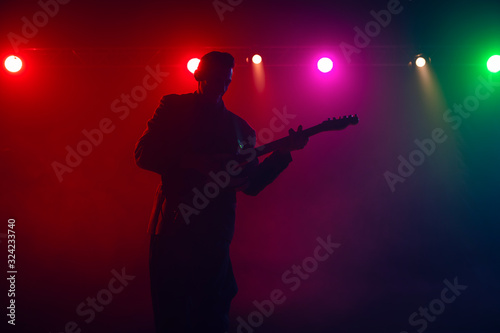 A guitarist perform on stage.
