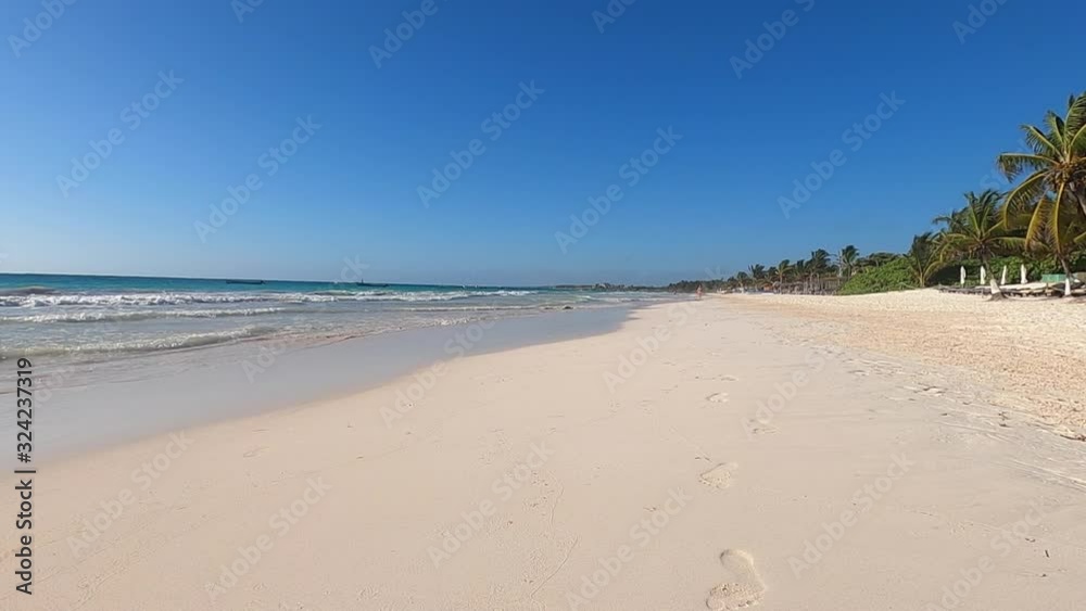Footprints in the sand. Video of sea waves washing away footprints on golden sand at the beach in slow motion in Tulum Mexico Footprints in the sand. Video of sea waves washing away footprints on golden sand at the beach in slow motion in Tulum Mexico