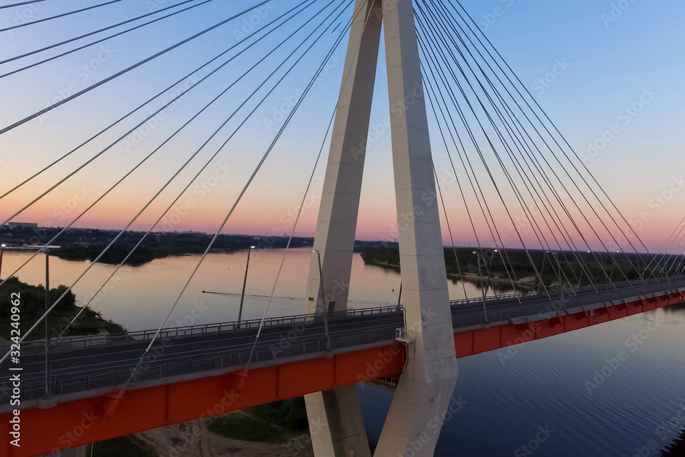 Obraz premium Beautiful bridge over the river. The bridge on the cables is roa