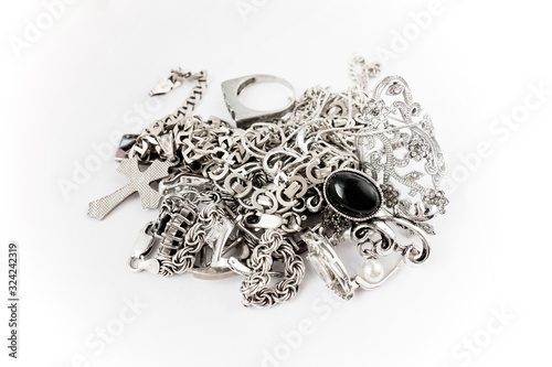 A pile of silver precious jewelry with and without stones. Isolated on white