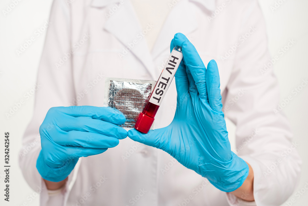 cropped view of scientist in latex gloves holding sample with hiv test lettering and condom isolated on white cropped view of scientist in latex gloves holding sample with hiv test lettering and condom isolated on white