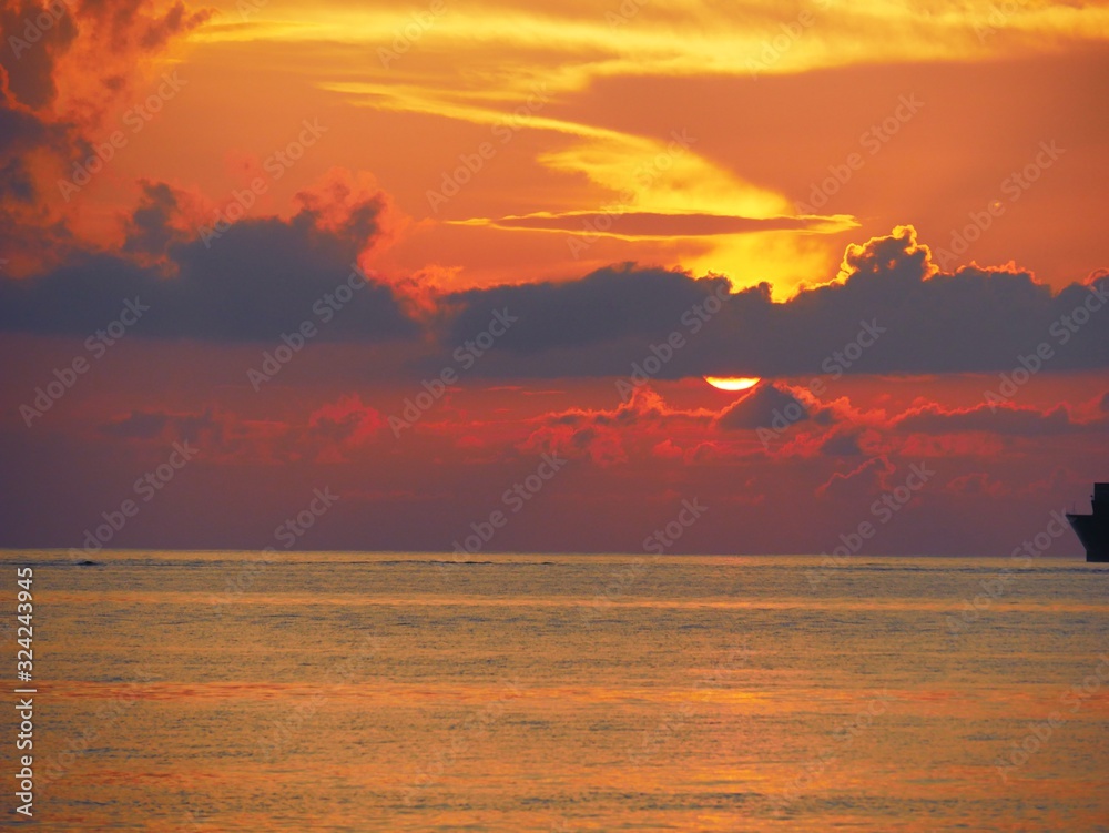 Sunset reflected in the golden waters of Saipan, the Northern Mariana Islands.