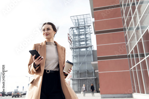 Young Businesswoman Smiling While Using a Mobile Phone