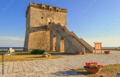 Picturesque historical fortification tower Torre Lapillo (St. Thomas Tower, Torre di San Tommaso) on Salento Ionian sea coast, Puglia, Italy. photo