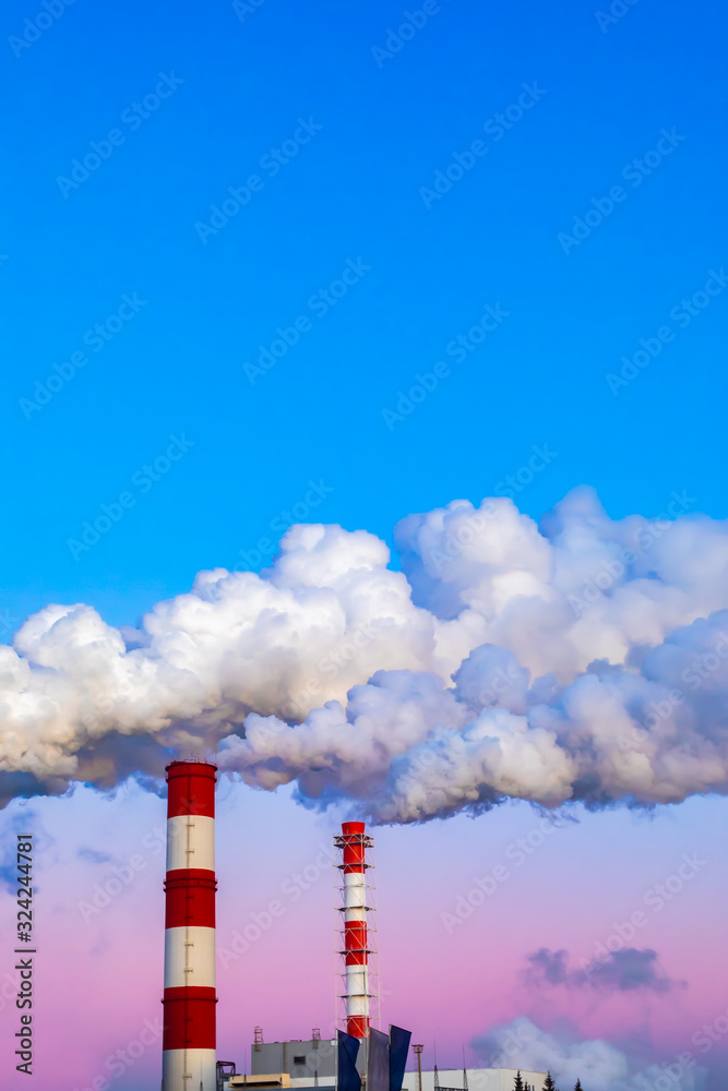 Factory chimneys pollute the air, thick smoke painted by sunset, the evening sky twilight. environmental problems, global warming and air pollution Factory chimneys pollute the air, thick smoke painted by sunset, the evening sky twilight. environmental problems, global warming and air pollution