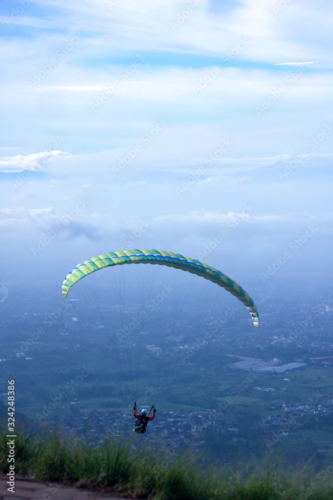 Paragliding hovering above the city in the morning