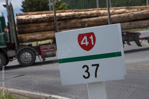 Signs at Highway 41 New Zealand. Logging truck