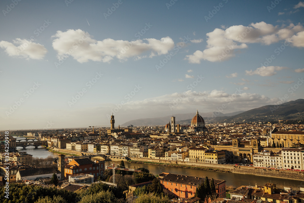 Aerial panoramic view of old city of Florence and Cattedrale di Santa Maria del Fiore (Cathedral of Saint Mary of the Flower), Palazzo Vecchio. Panorama of Florence and river Arno in sunny day Tuscany