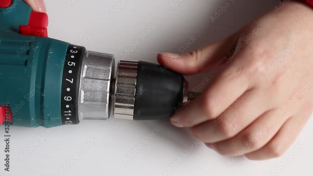 Preparation for work. Close up of man worker used electric powered screwdriver for drilling wood with screw twisted into place. Preparation for work. Close up of man worker used electric powered screwdriver for drilling wood with screw twisted into place.
