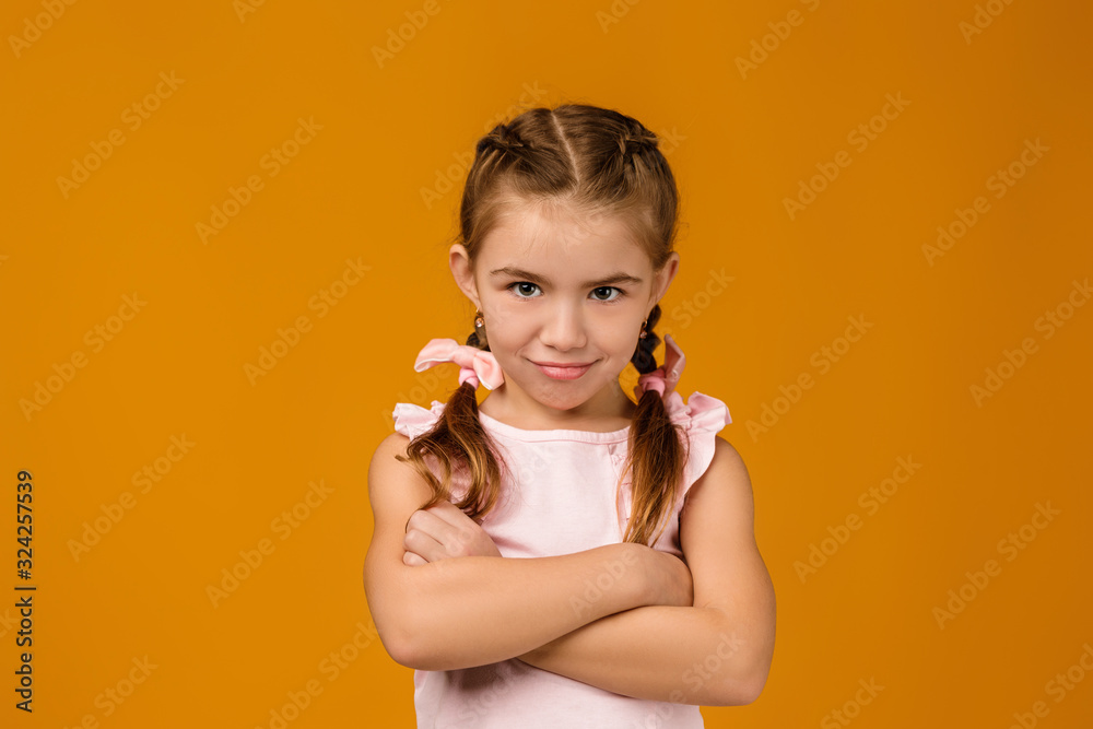 offended sad little child girl in dress on yellow background. Human emotions and facial expression offended sad little child girl in dress on yellow background. Human emotions and facial expression