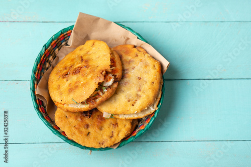 Mexican gorditas with pressed chicharron on turquoise background photo