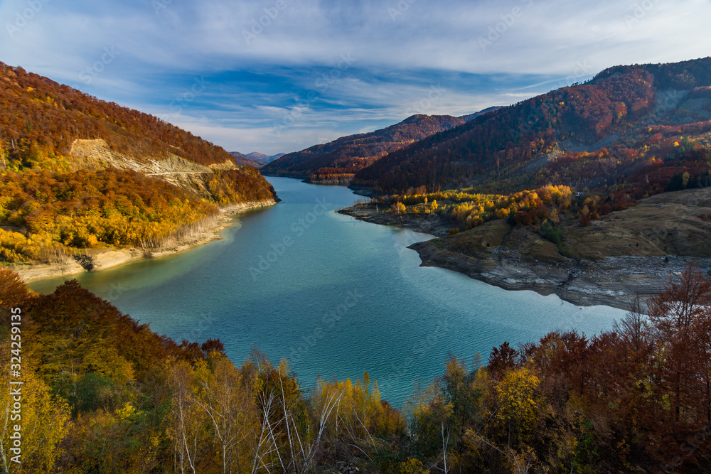 Beautiful autumn landscape with golden colored trees on the shores of Siriu lake, Siriu Dam, Buzau River