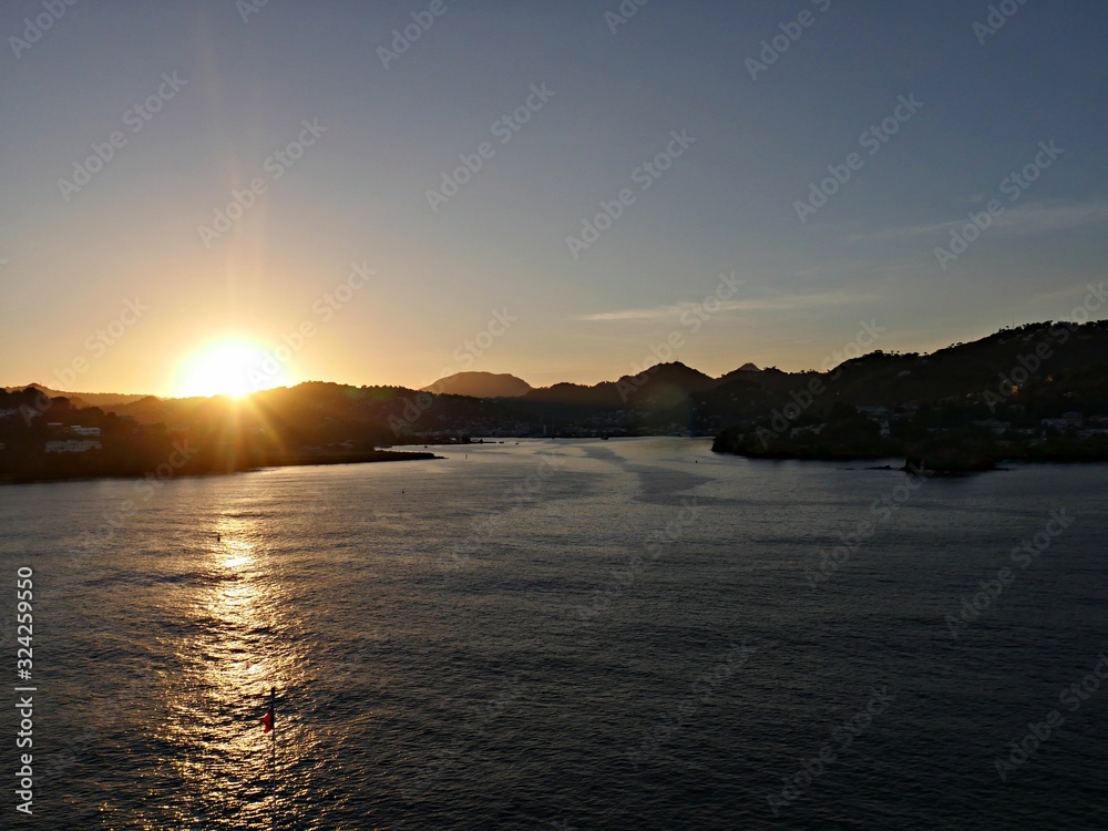Dawn of another day as the sun rises from the horizon over St. Lucia in the Caribbean Sea. Dawn of another day as the sun rises from the horizon over St. Lucia in the Caribbean Sea.