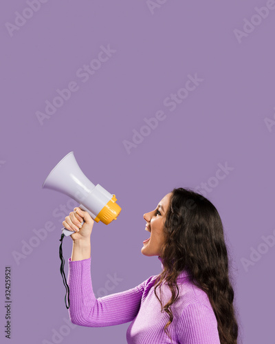 Woman shouting in megaphone and copy space