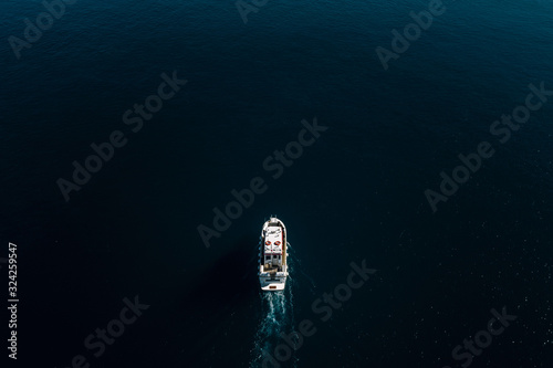 Whale watching boat crossing deep waters in Greenland photo