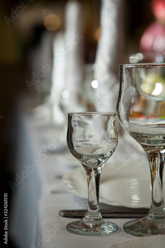 A wine glass stands on a table on a white tablecloth