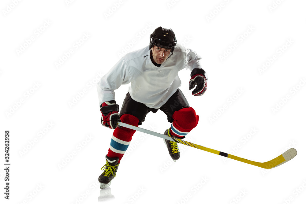 Character. Young male hockey player with the stick on ice court and white background. Sportsman wearing equipment and helmet practicing. Concept of sport, healthy lifestyle, motion, movement, action. Character. Young male hockey player with the stick on ice court and white background. Sportsman wearing equipment and helmet practicing. Concept of sport, healthy lifestyle, motion, movement, action.