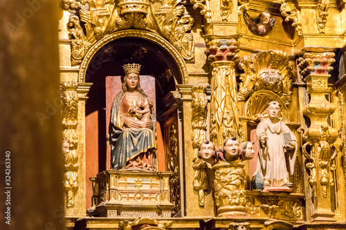 Cillorigo de Liebana, Spain. Wooden sculpture of the Lactant Virgin Mary in a golden altar in the Iglesia de Santa Maria (St Mary Church) of Lebena