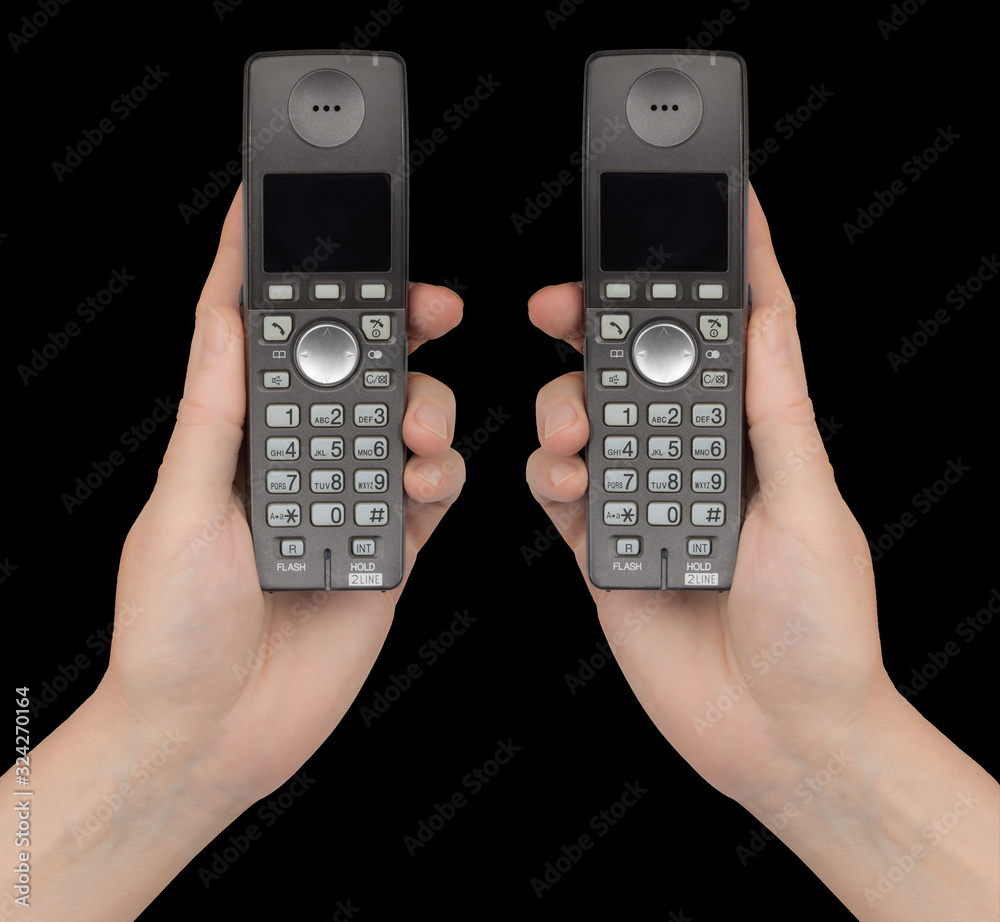 Female hands holds a phones, isolated on black background Female hands holds a phones, isolated on black background