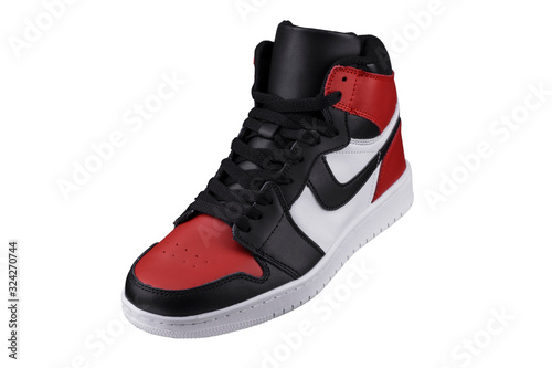 Side view of a high sneaker with red and black accents. photo