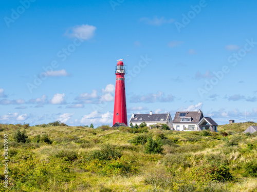 Lighthouse North Tower and houses in Westerduinen dunes on Schiermonnikoog, Netherlands photo