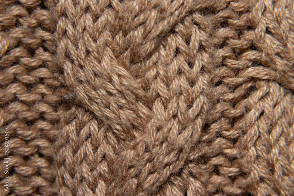 detail of embroidered wool sweater, braided in cream or camel, fabric detail detail of embroidered wool sweater, braided in cream or camel, fabric detail