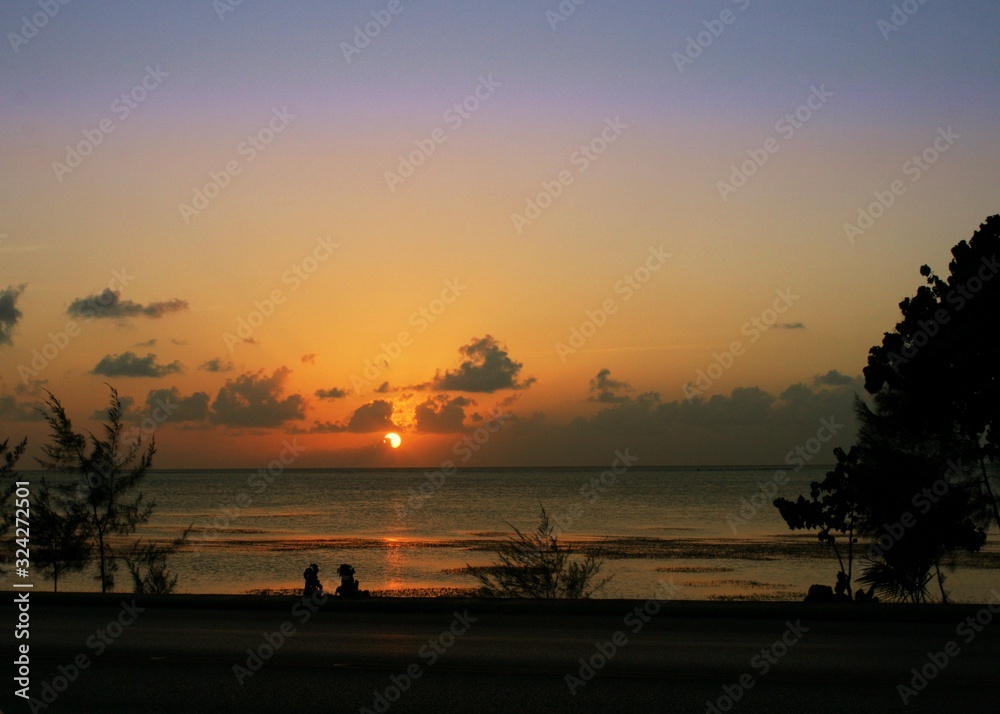 Beautiful sunset at the Beach Road on Saipan, Northern Mariana Islands.