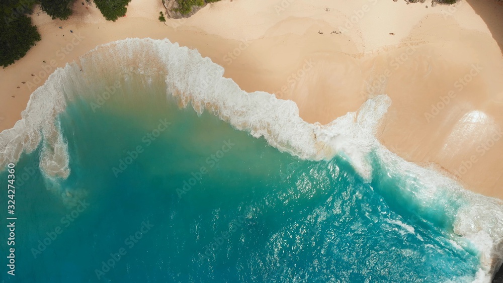 Sea waves Kelingking beach in Nusa Penida island, Bali, Indonesia. Drone view close up.