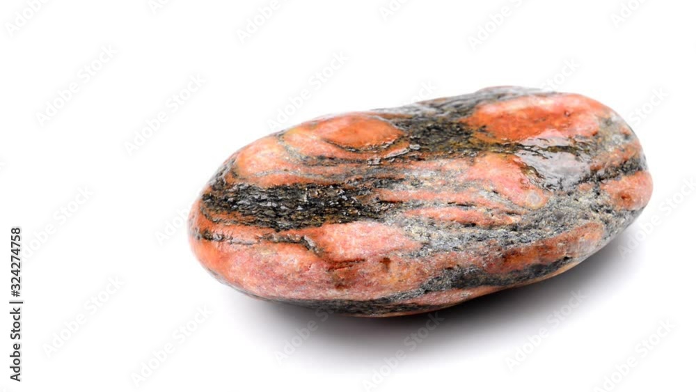 Gneiss with red feldspar eyes on a turn table