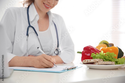 Nutritionist working at desk in office, closeup