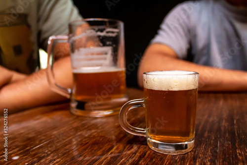 Small beer chopp. Big chopp and people on the background. Schop, Schopp, Schoppen. photo