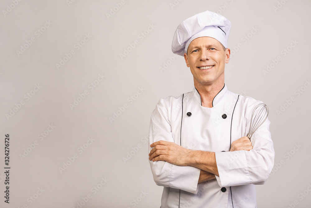 Smiling senior male chef isolated over white background.