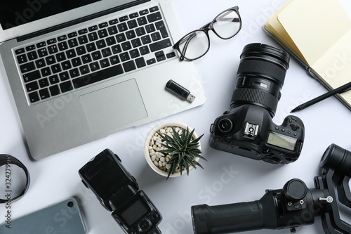 Composition with camera and video production equipment on white background, top view photo