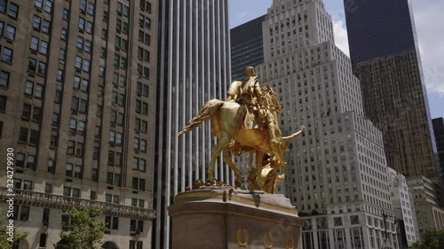 Cinematic shot rotating around golden statue with NYC buildings parallax in midtown manhattan